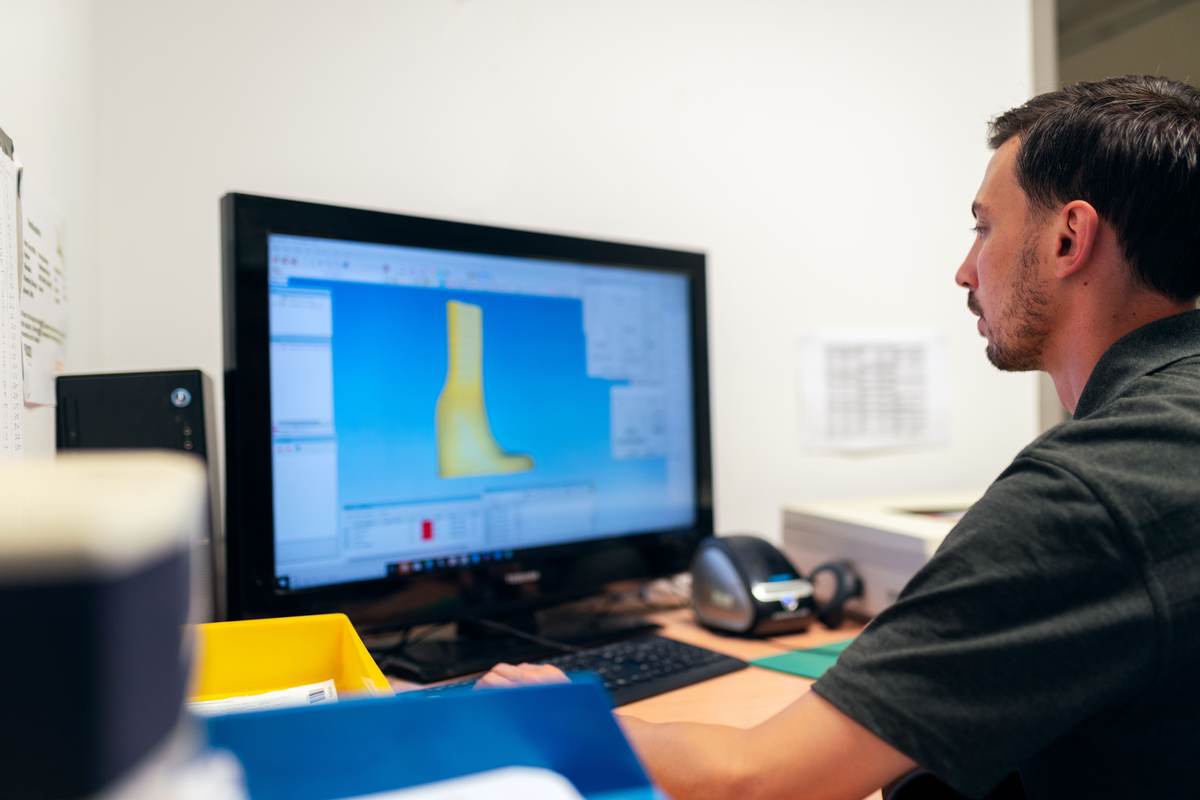 An engineer designing a prosthetic using CAD software