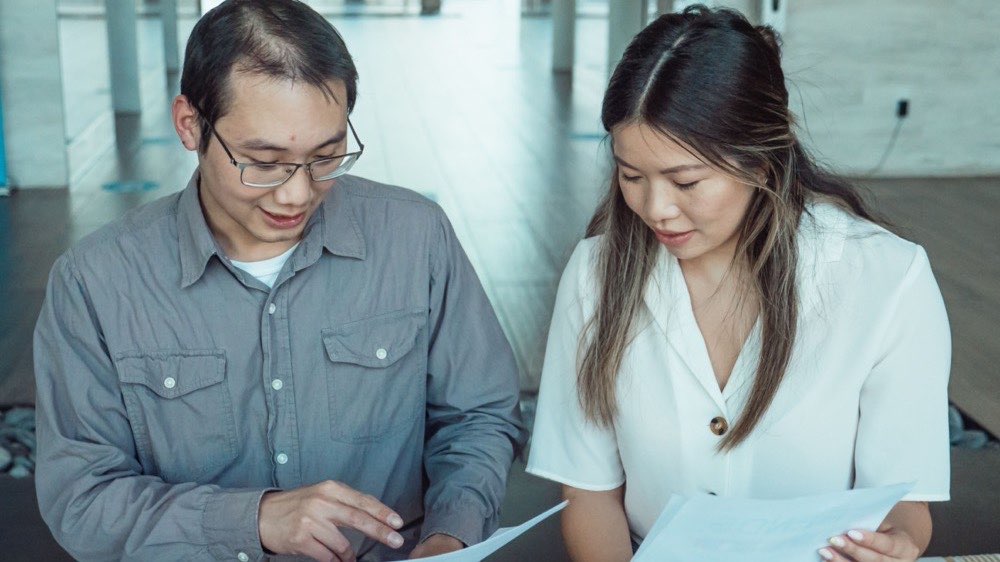 Senior regulatory scientists reviewing a New Drug Application dossier together