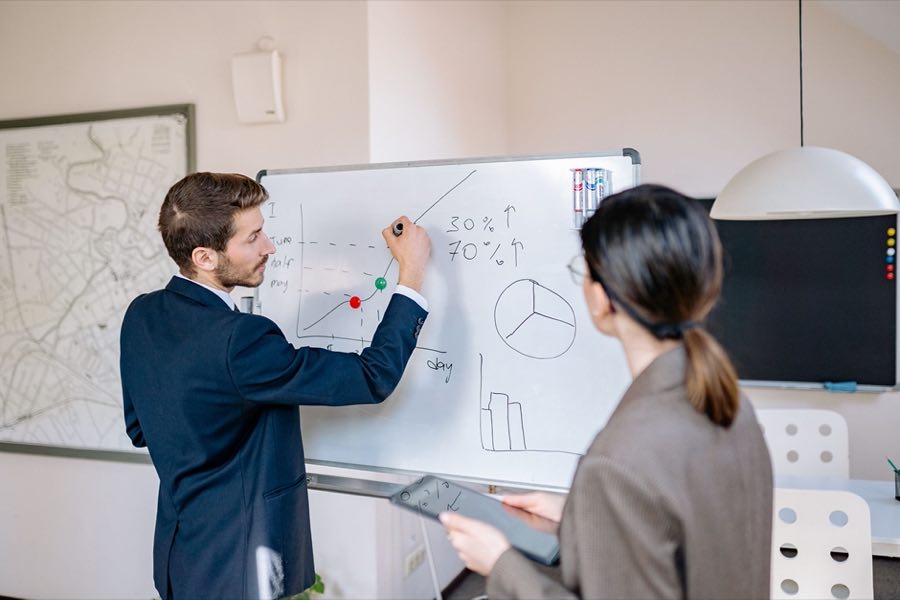 Regulatory leaders mapping strategy at a whiteboard