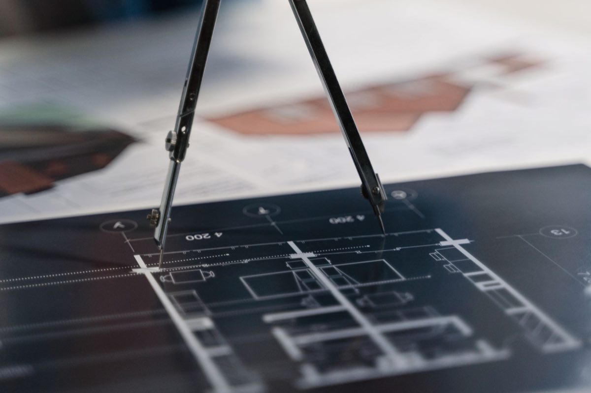 Compass on architectural plans representing a coordinated multi-region expedited strategy
