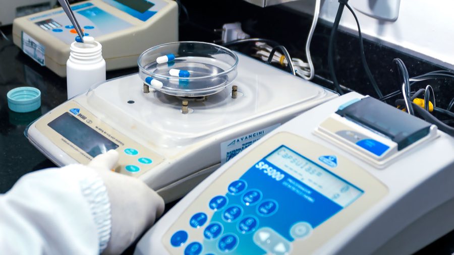 Analytical balance and sample vials in a quality-control laboratory