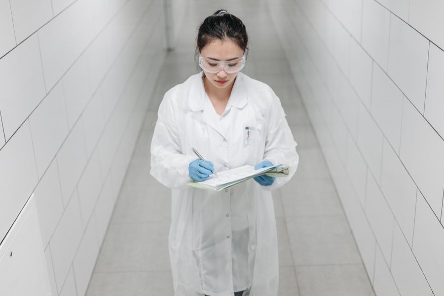 Regulatory scientist reviewing documentation on a clipboard
