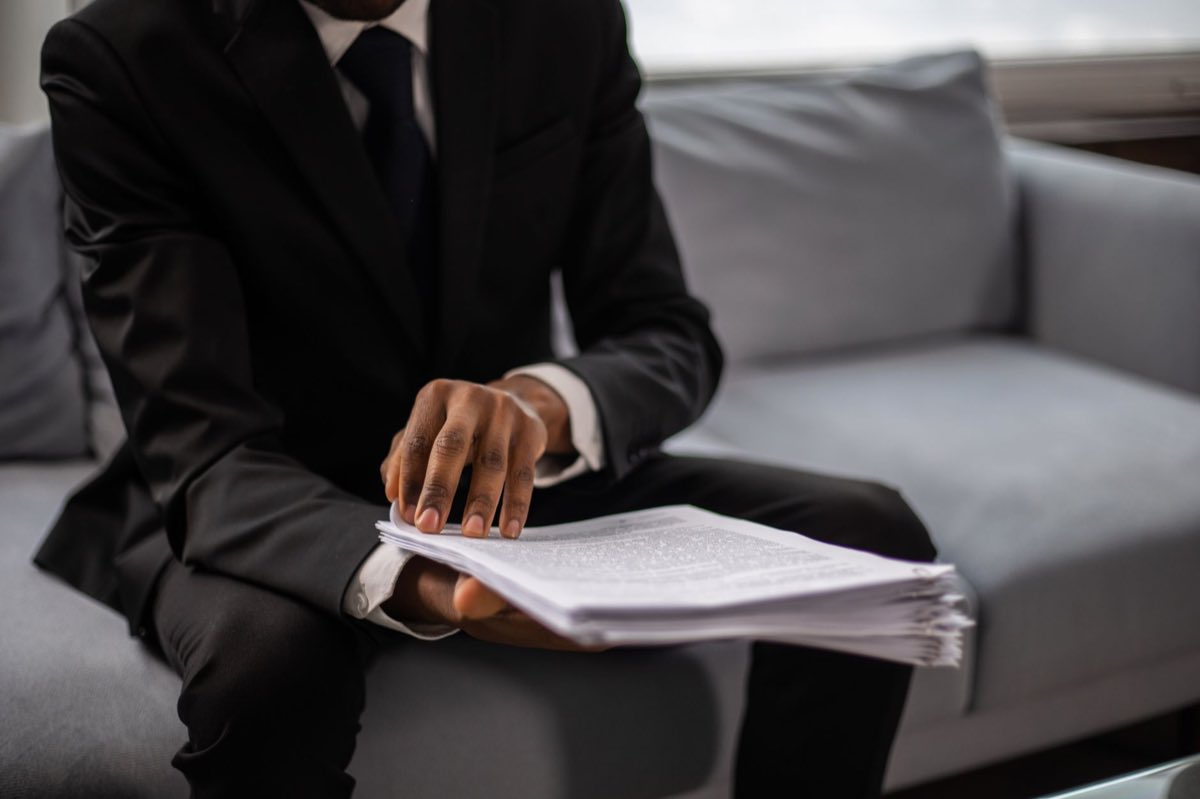 An executive reviewing a stack of legal documents