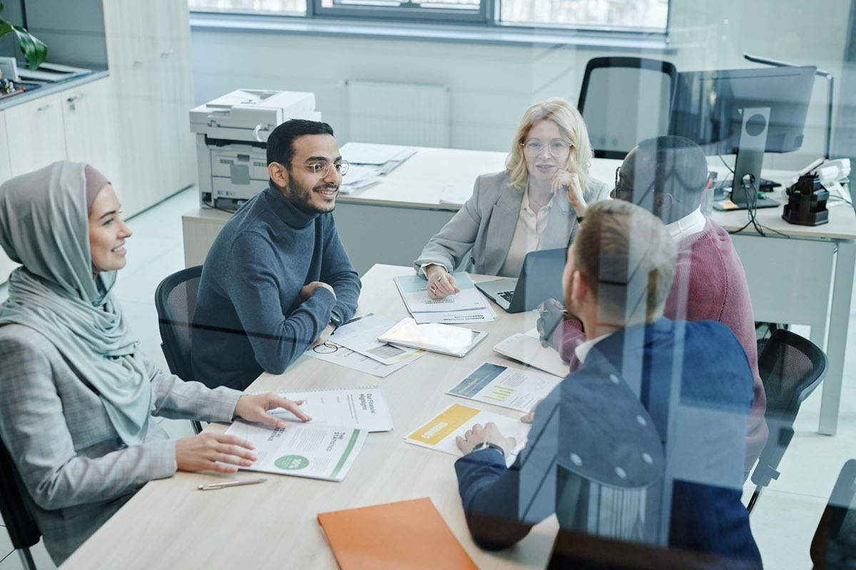 Medical and regulatory reviewers examining promotional materials around a table
