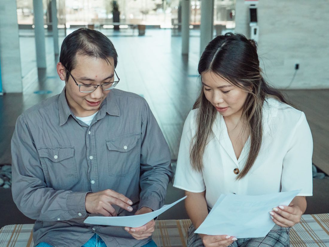 Two reviewers comparing a promotional piece against source data