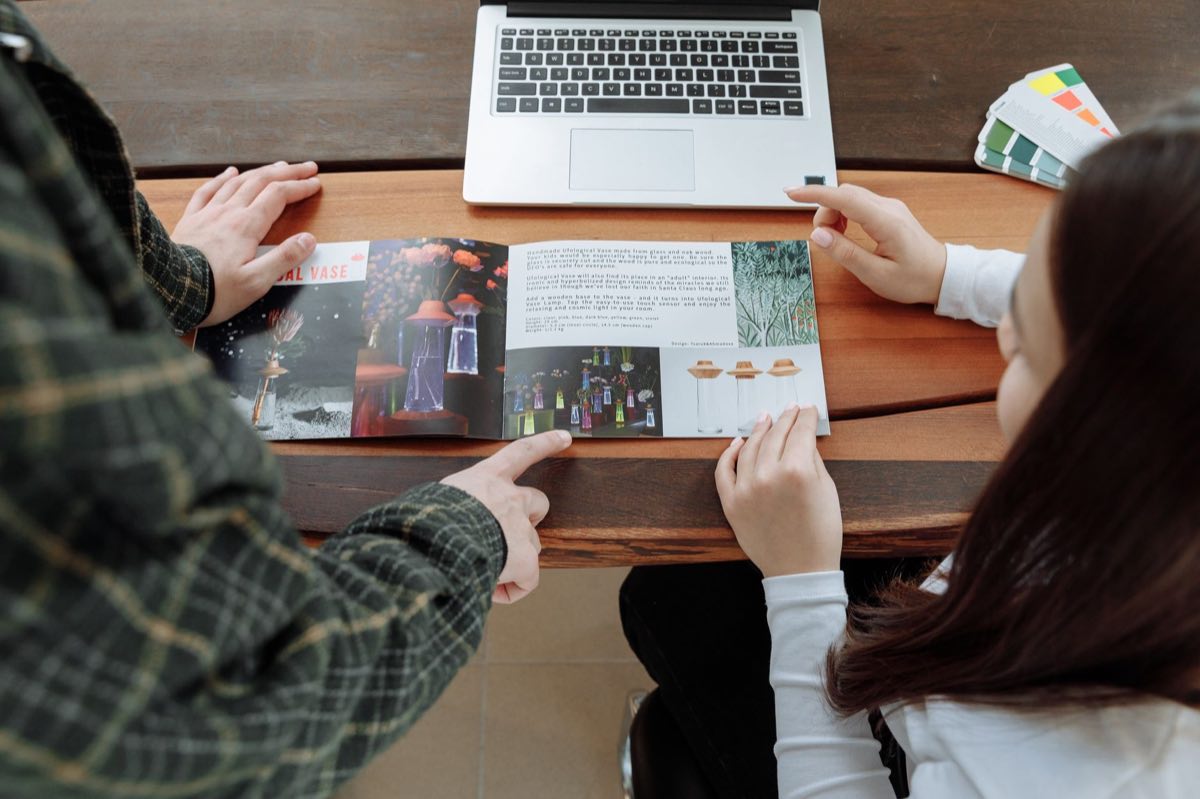 Team reviewing a promotional brochure and color proofs against the approved label
