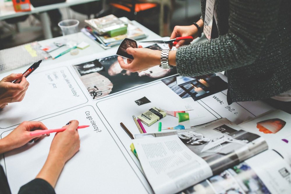 Promotional review team assessing marketing creative around a table