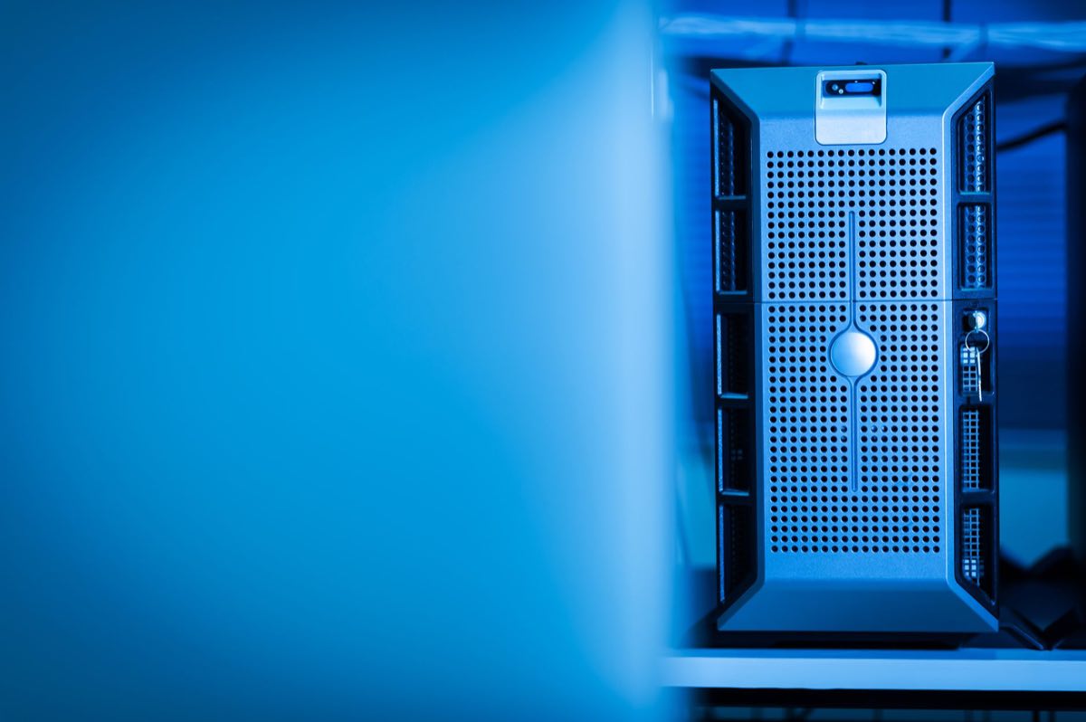 A modern server unit glowing blue in a data center