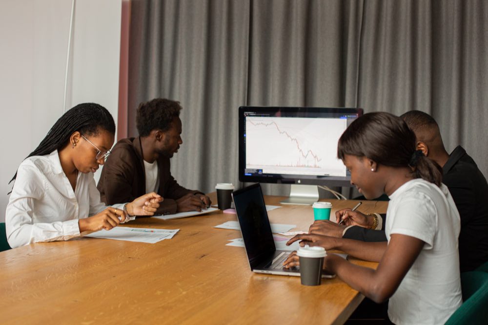 A diverse group of professionals analyzing data during an office meeting