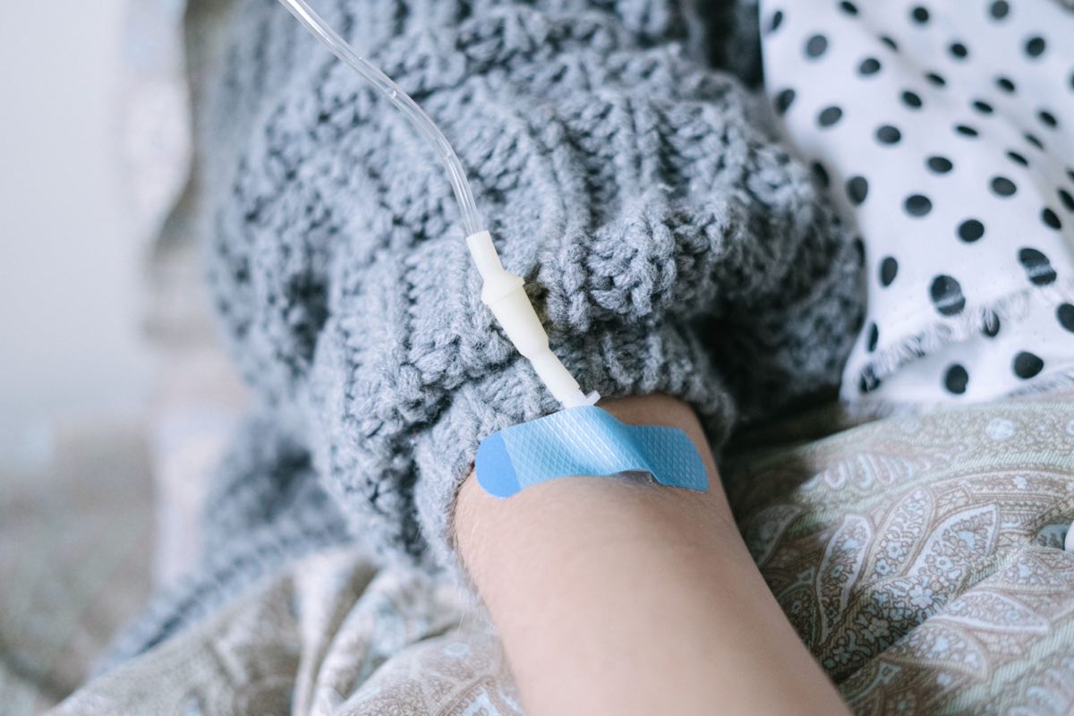 Close-up of a patient receiving intravenous therapy during cancer treatment