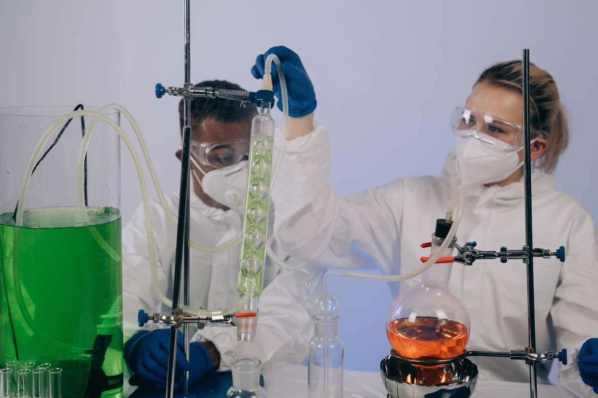 Researchers in protective gear performing an experiment in a laboratory