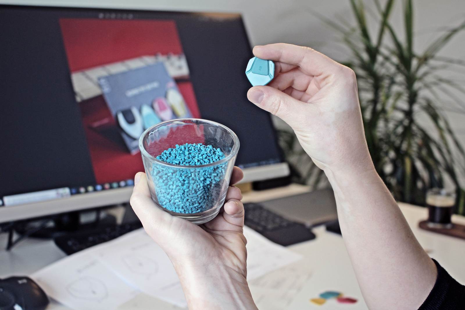 Hands holding plastic granules used as printing material