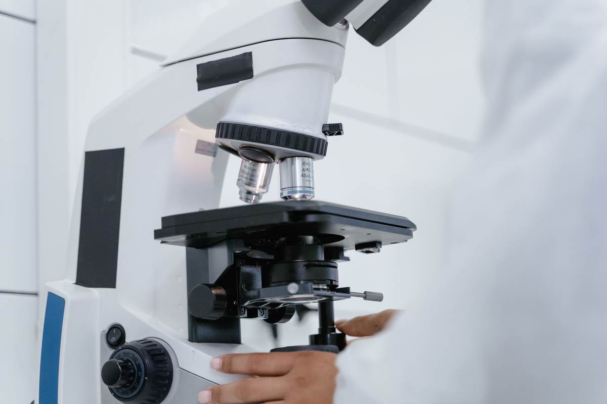 A scientist operating a microscope in a laboratory