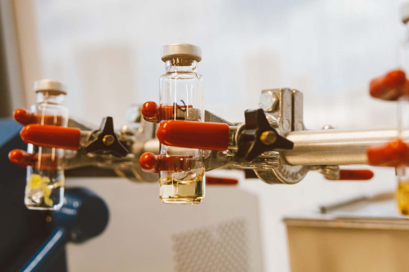 Matching glass vials held in laboratory clamps