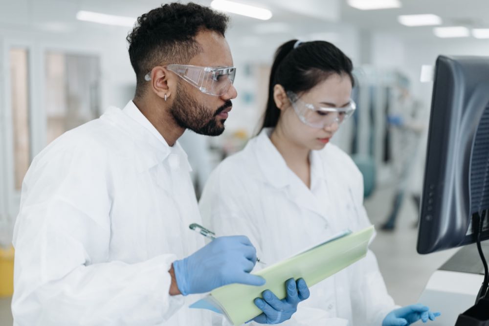 Two scientists conducting research together in a modern laboratory