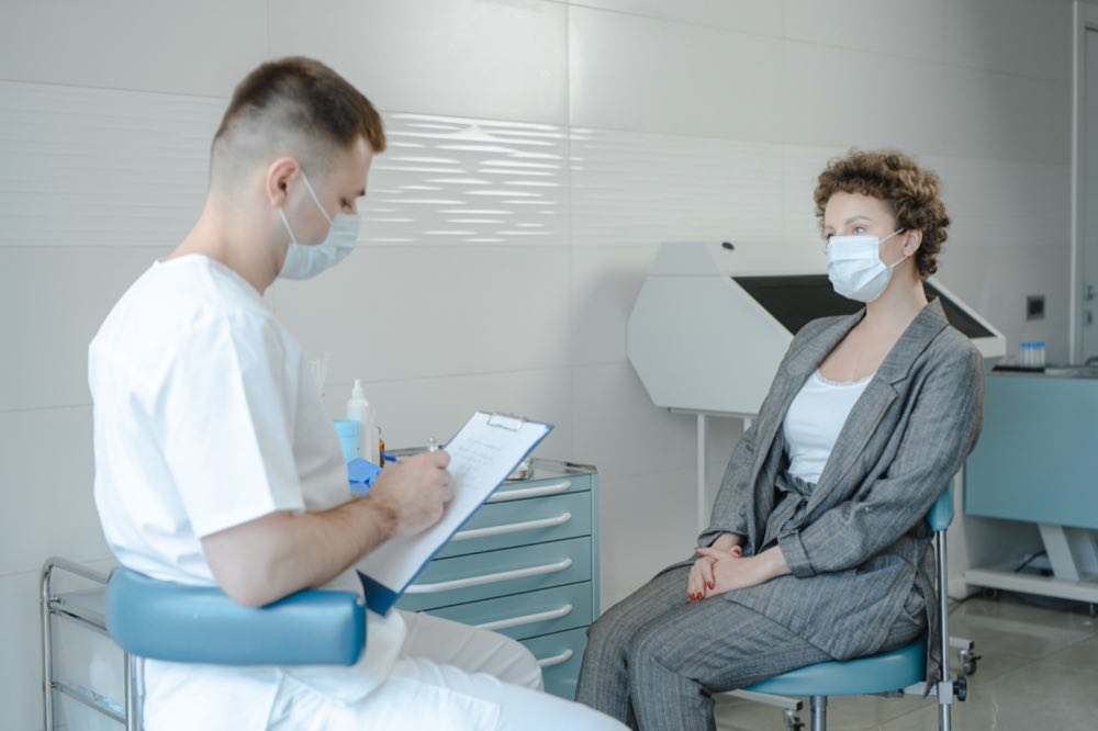 A physician consulting with a patient in a clinic