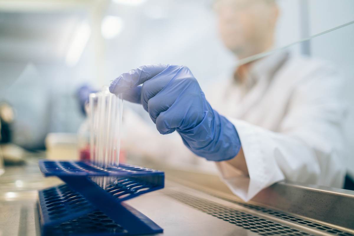 A scientist handling test samples in a laboratory