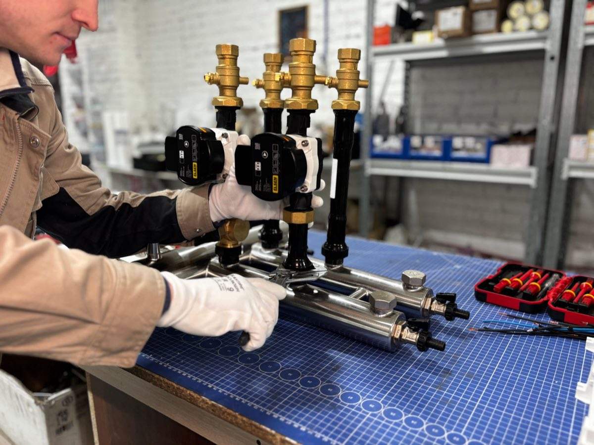Engineer assembling an industrial piping system with valves