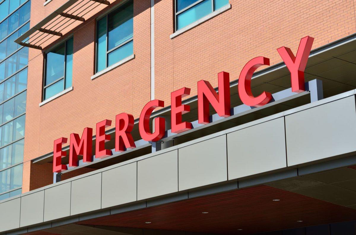 A hospital emergency entrance with a prominent red EMERGENCY sign