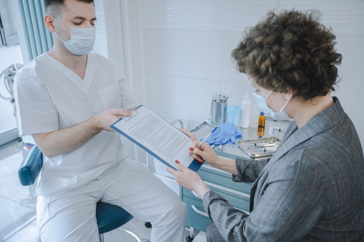 Clinical monitor reviewing trial records at a site