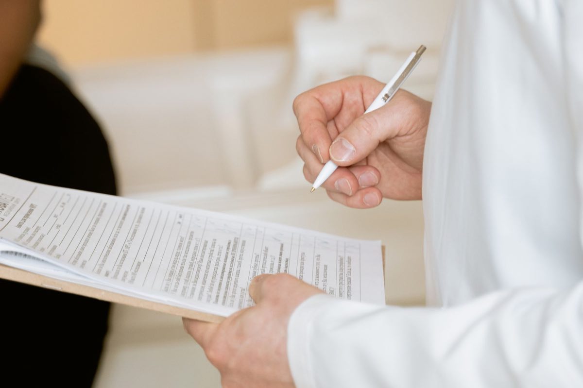 Clinician reviewing trial documents on a clipboard