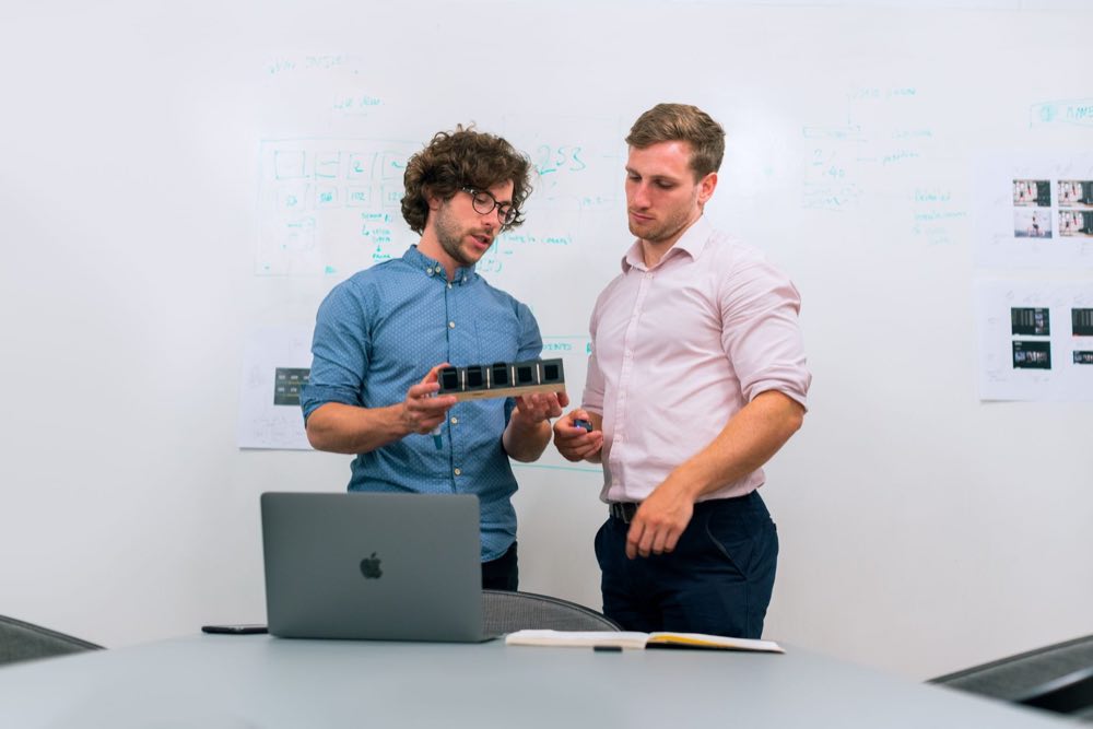 Regulatory and engineering leads reviewing a combination-product device constituent together