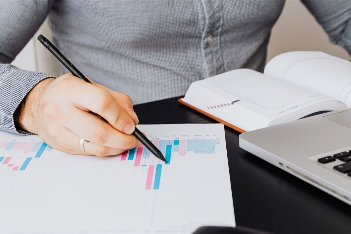 Regulatory professional preparing an adverse event report on screen