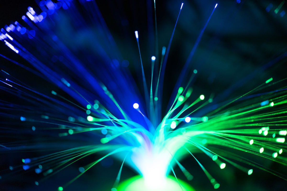 Illuminated fiber optic strands glowing blue and green