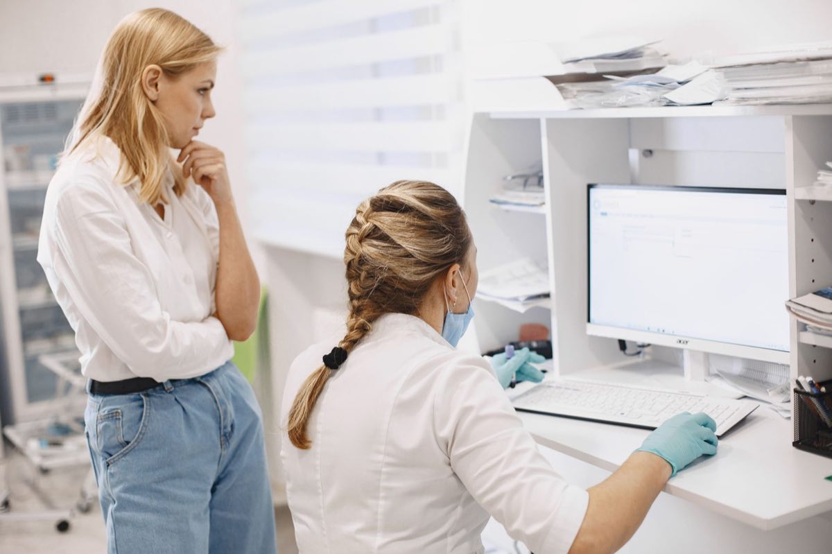 Laboratory staff reviewing electronic records at the point of creation