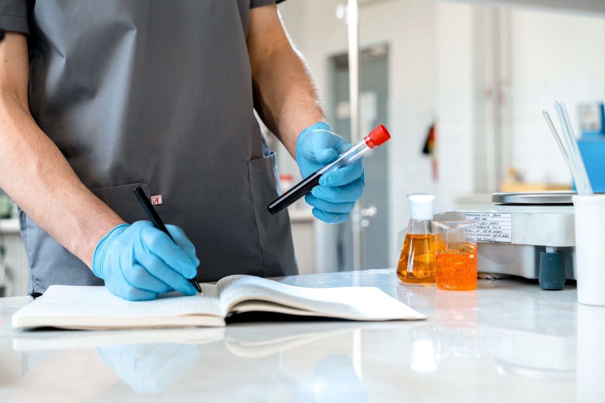 Scientist recording observations in a laboratory notebook