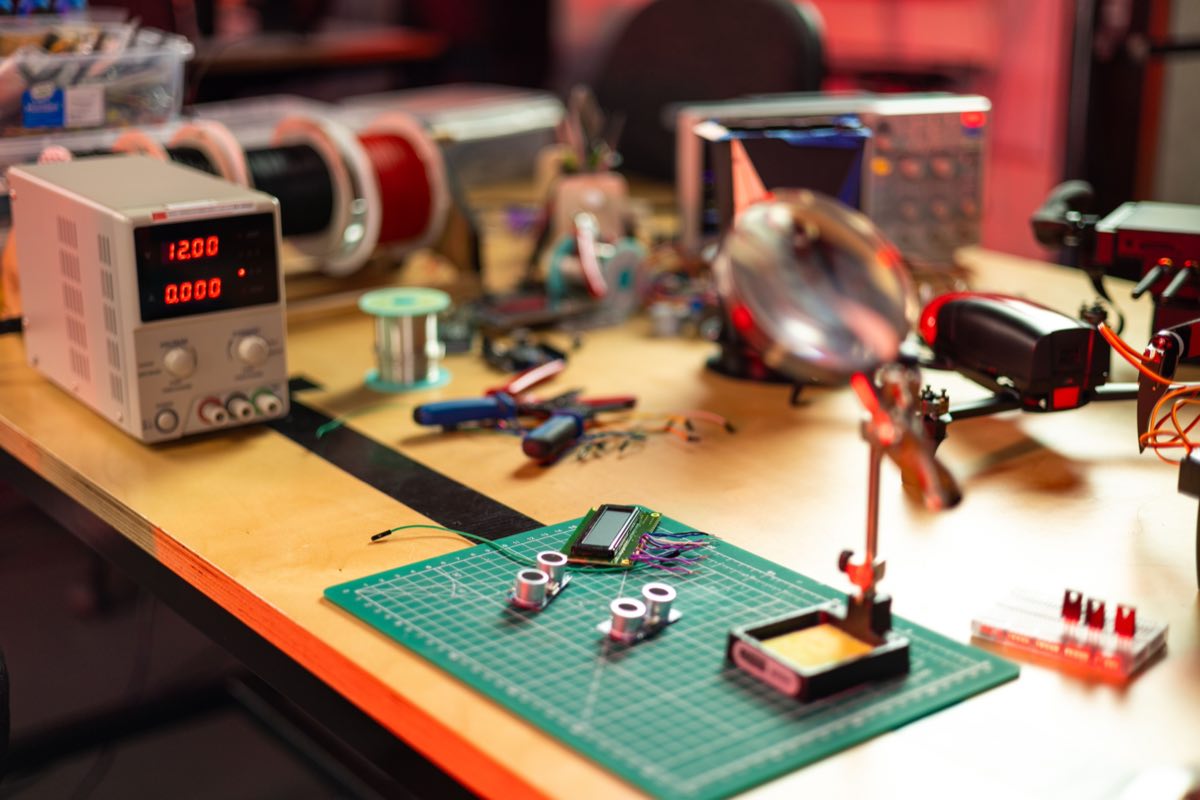 An electronics workbench with instruments and tools mid-project