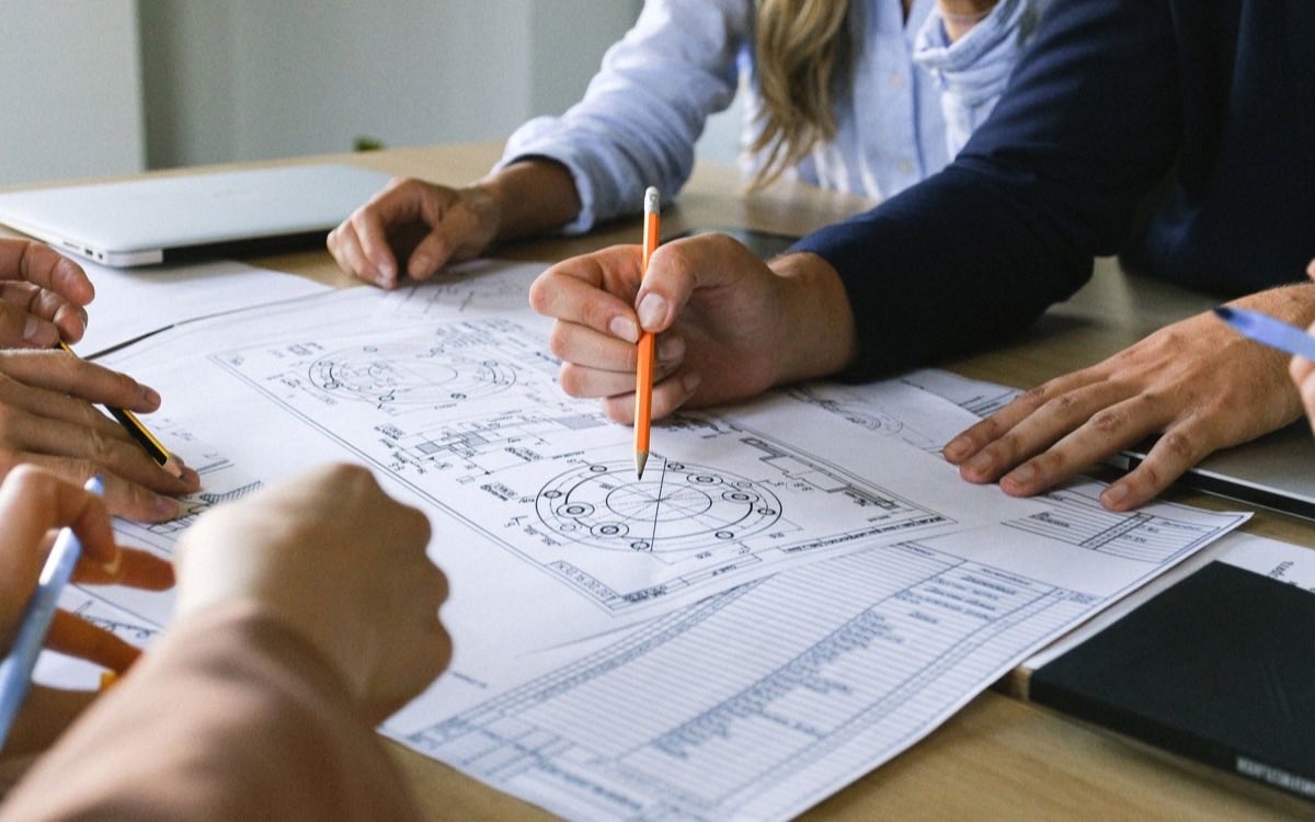 Engineers reviewing medical device design specifications and drawings