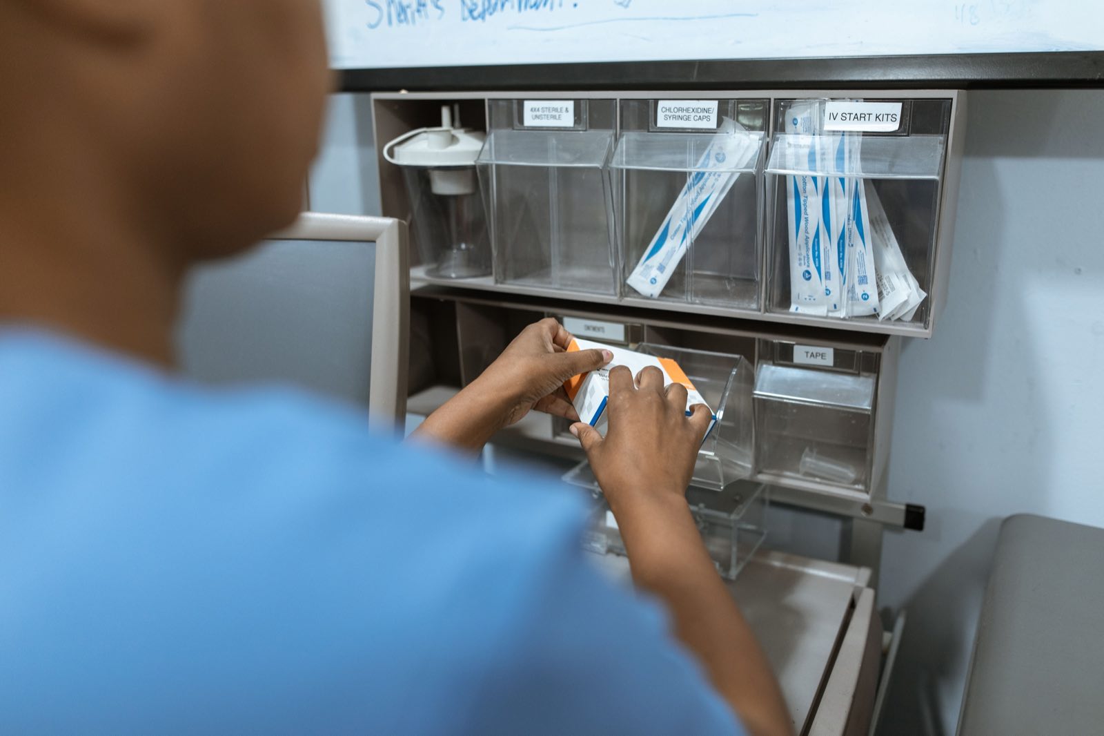 A healthcare professional organizing medical supplies in a hospital store room