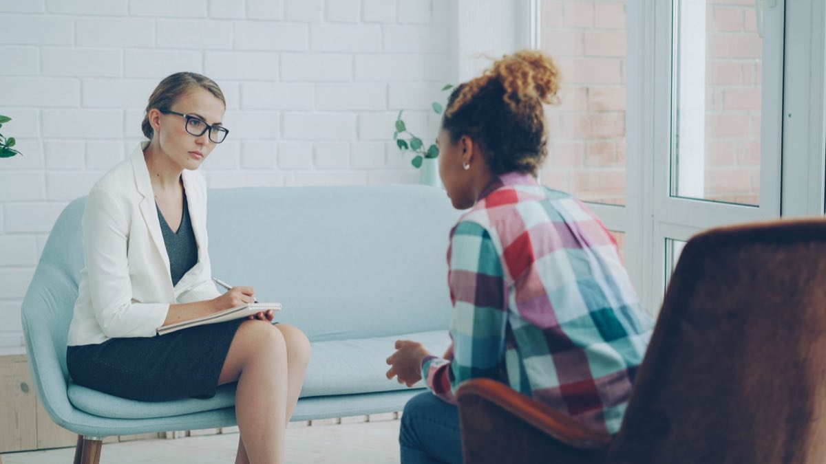 A therapist listening attentively during a private counseling session
