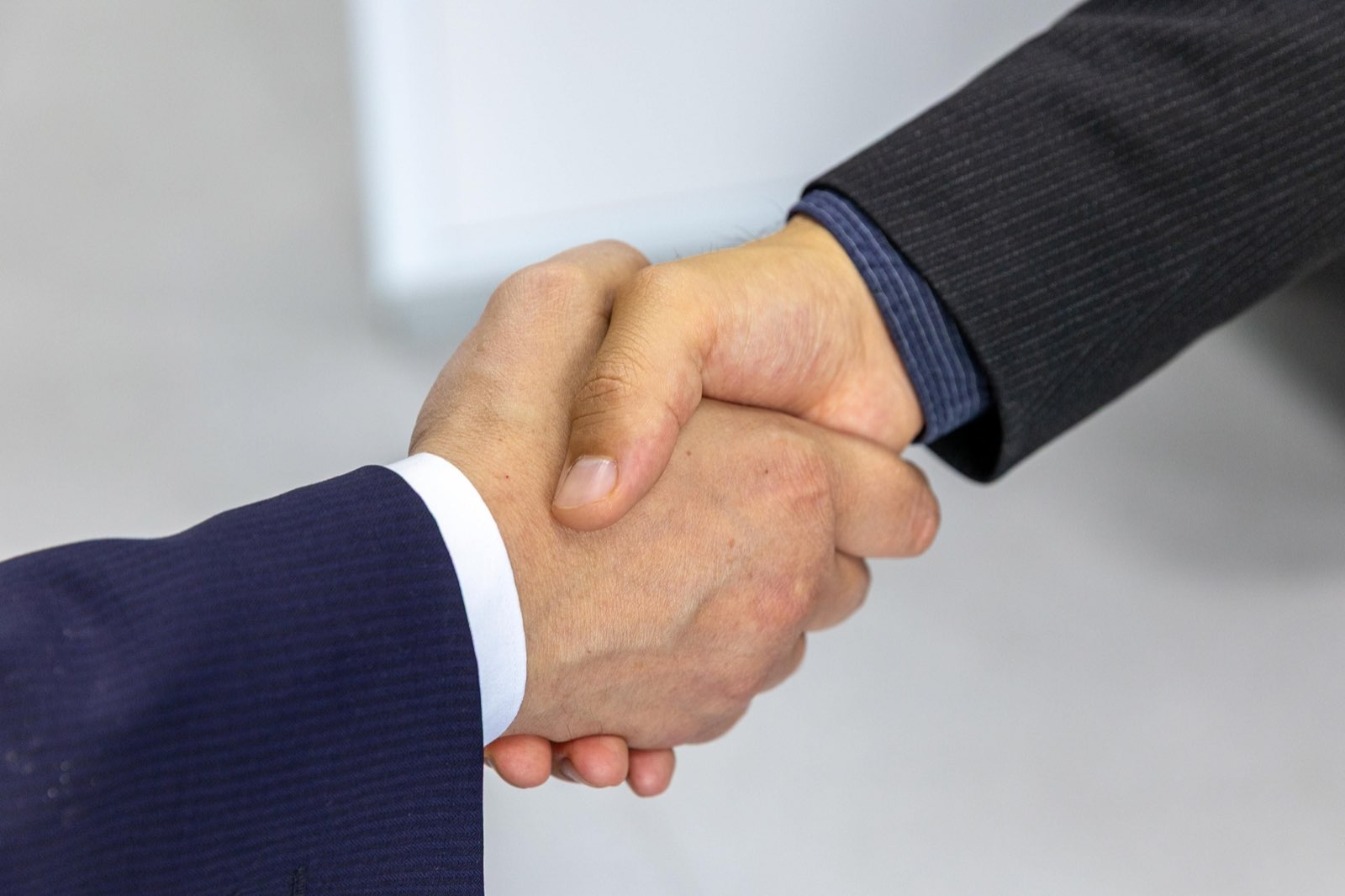 Two parties shaking hands to close a transaction