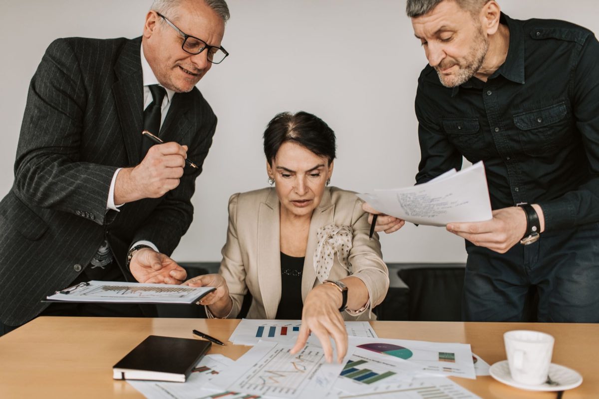 Diligence team examining a target company's records across the deal table