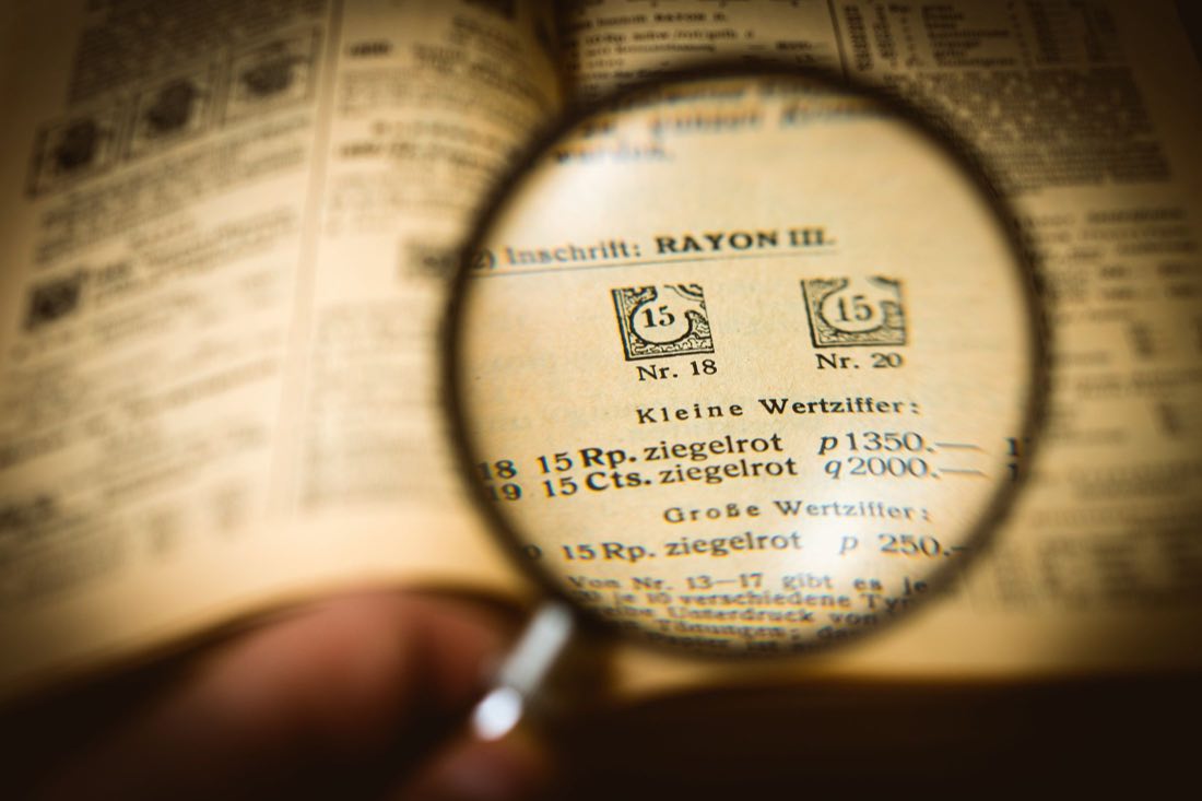 A magnifying glass held over printed records