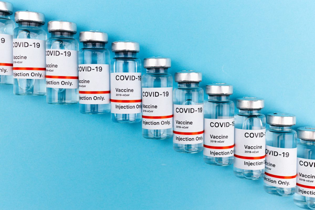 Rows of vaccine vials lined up on a production surface