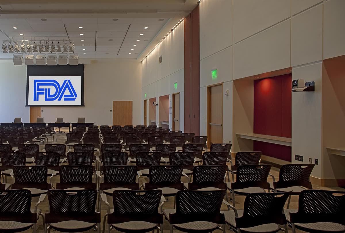 Rows of empty seats facing the panel table in FDA's Great Room at White Oak