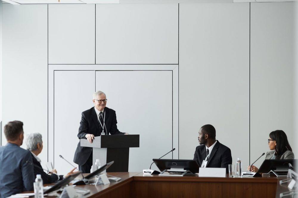Sponsor presenting to a panel of reviewers in a formal meeting
