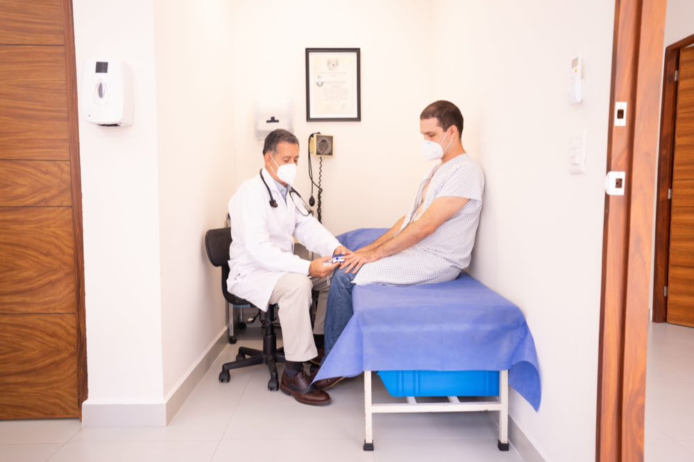 Doctor checking patient's vitals in a clinical setting for health consultation