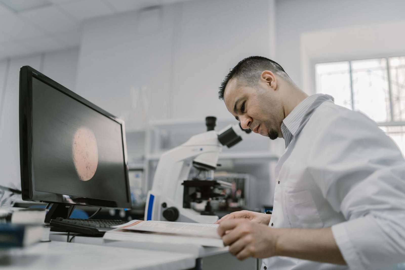 A researcher working with genetic analysis equipment in a laboratory