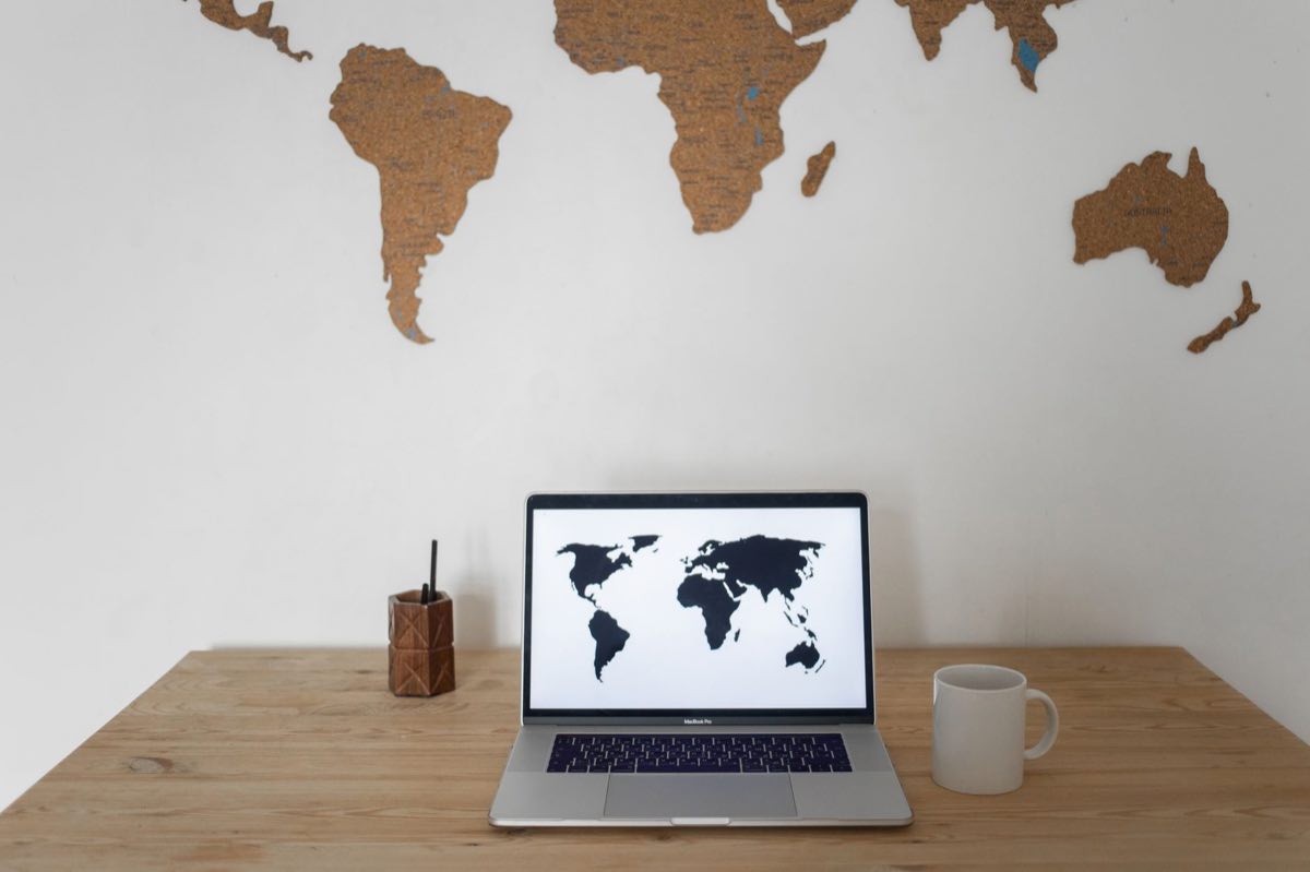 World map on a screen representing a coordinated multi-region regulatory campaign