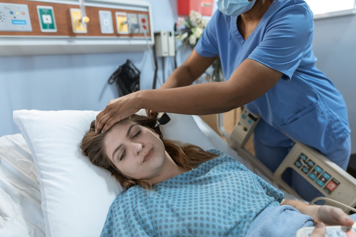 Physician performing an examination of a clinical trial participant
