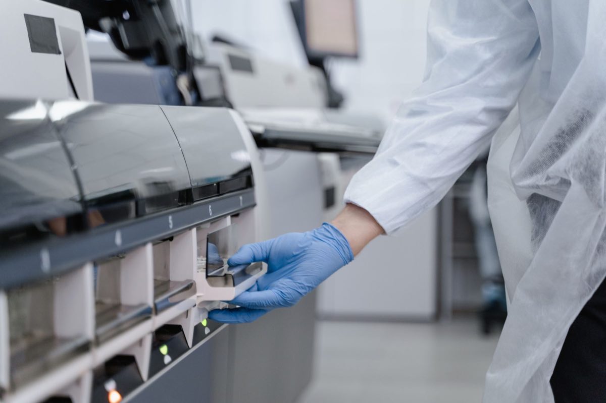 Laboratory technician working with precision equipment in a sterile environment