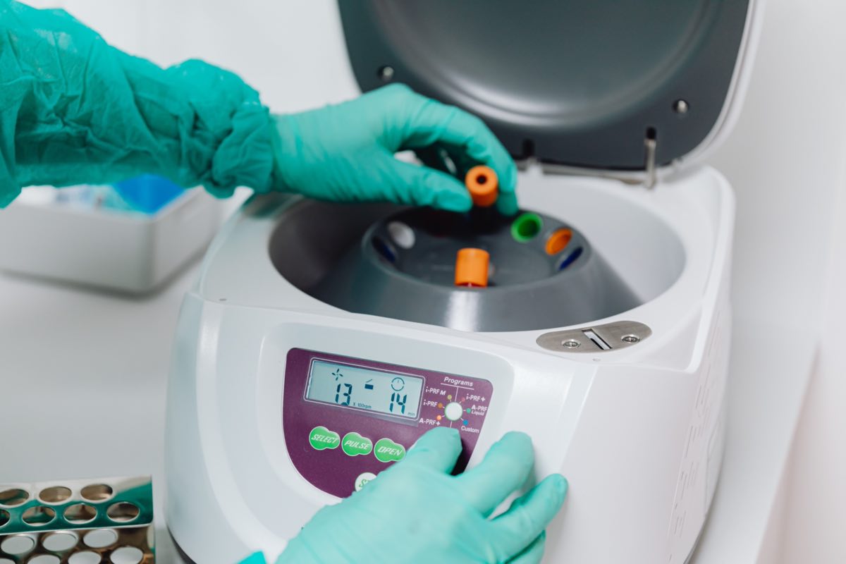 Laboratory technician processing blood samples in a centrifuge