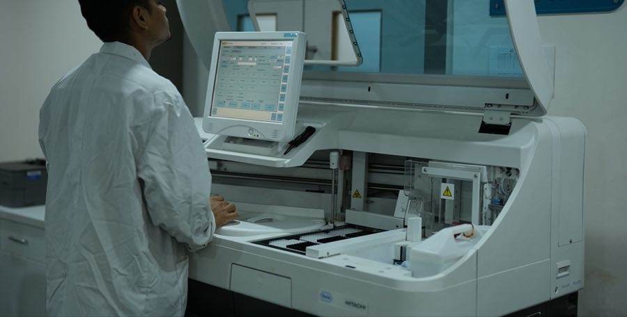 Laboratory technician operating a clinical diagnostics analyzer