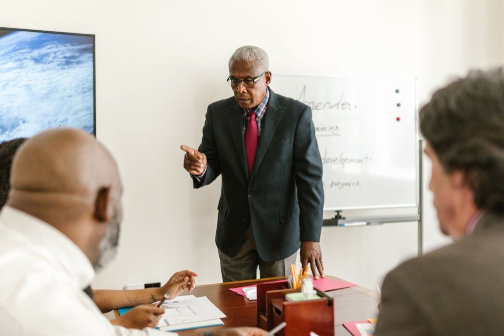 A senior regulatory leader heading a team meeting
