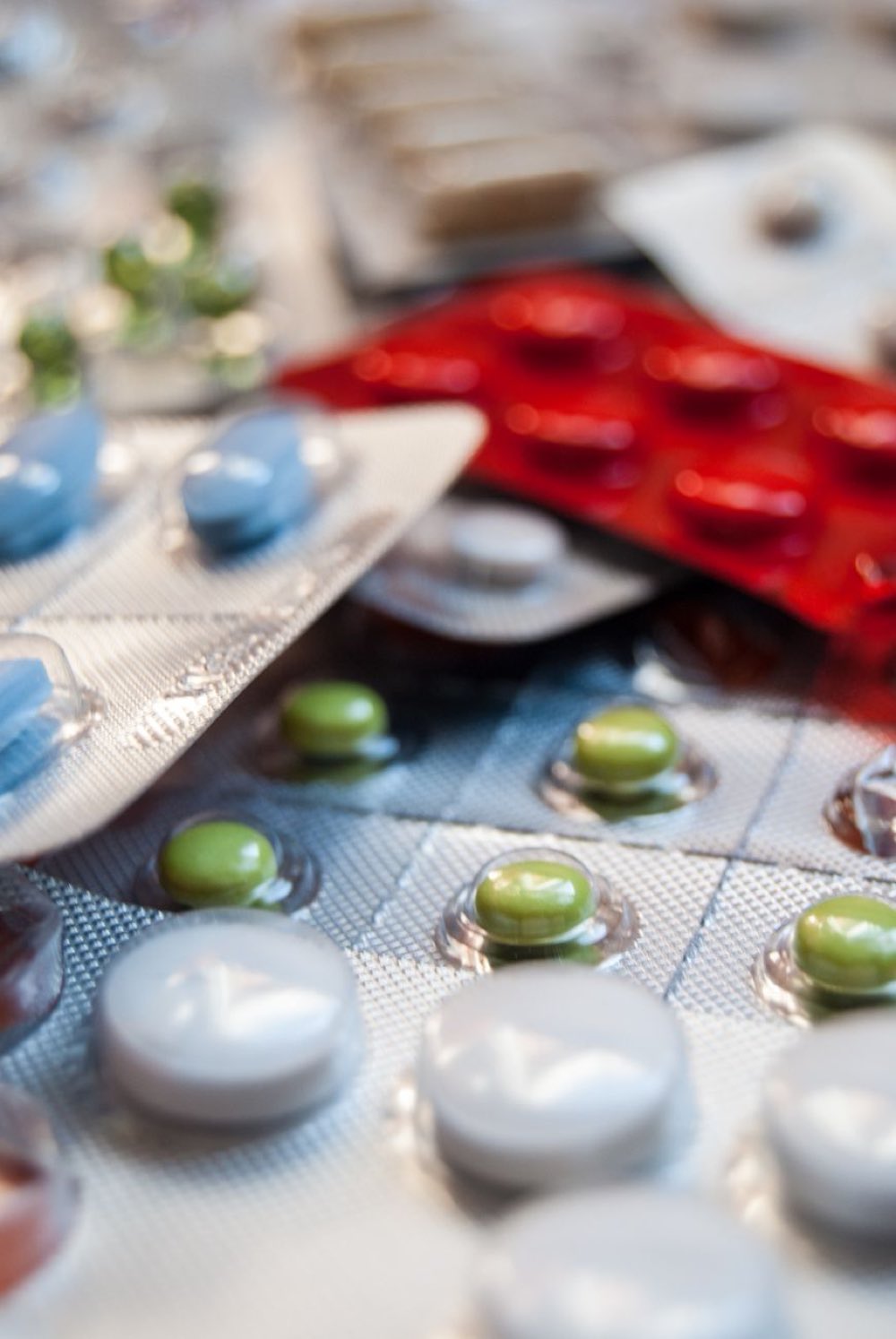 Tablets and capsules in blister packs, close up