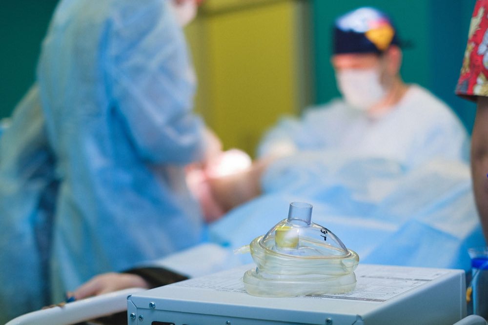 Medical team performing surgery in a sterile hospital operating room